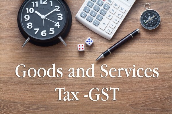 Image That Represents the Text Goods and Services Tax - With Calculator, Coins and Clock.