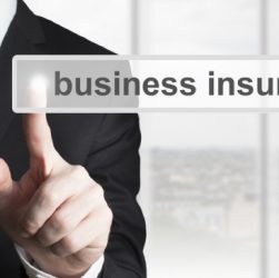 A Business man pointing on business insurance on the screen.