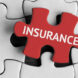 A jigsaw puzzle with the insurance word piece in the centre in red